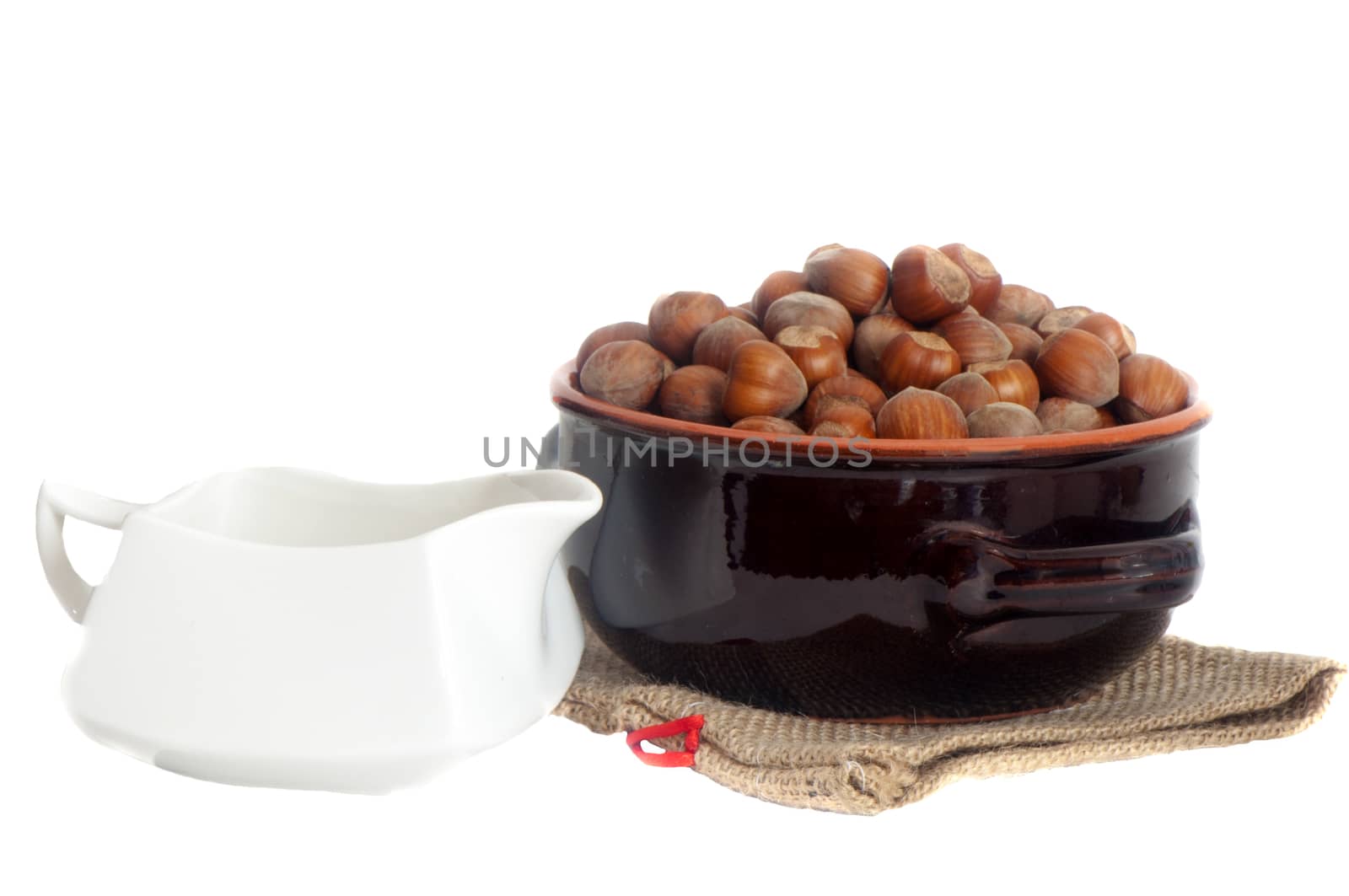 some hazelnuts placed over a white background