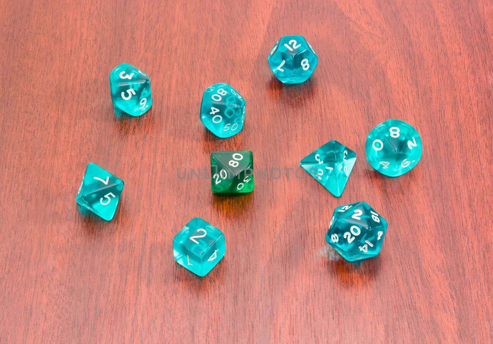 Specialized polyhedral dice for role-playing games on wooden sur by anmbph