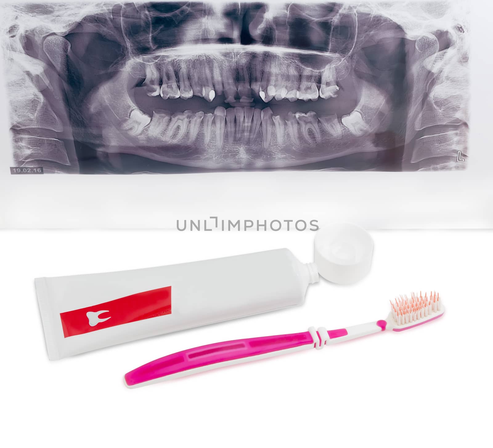 Toothpaste and toothbrush on background dental panoramic radiogr by anmbph