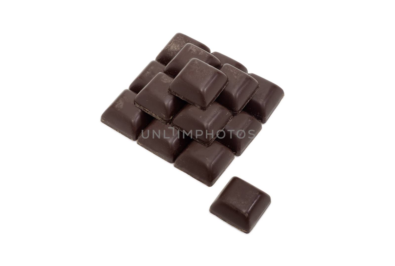 Pieces of dark chocolate on a light background by anmbph