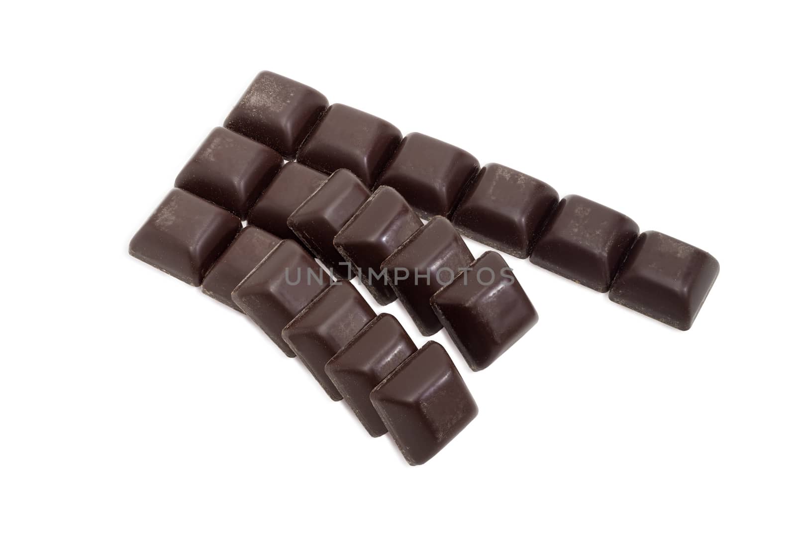 Slices of dark chocolate on a light background by anmbph