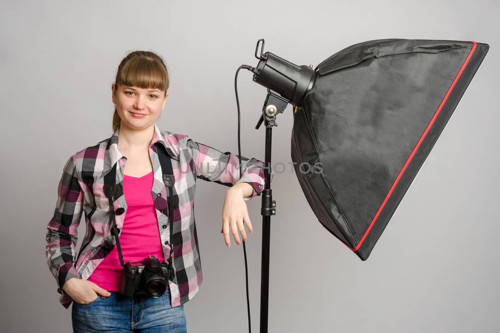 Portrait of a girl the photographer at the studio softbox