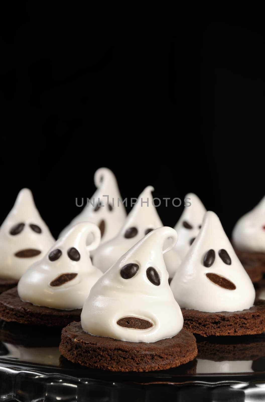 Chocolate biscuits decorated with meringue as a ghost for Halloween