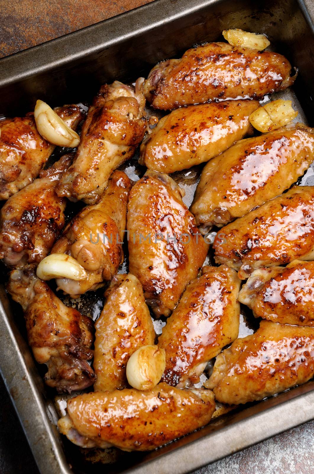 Fried sharply spicy chicken wings on a baking 