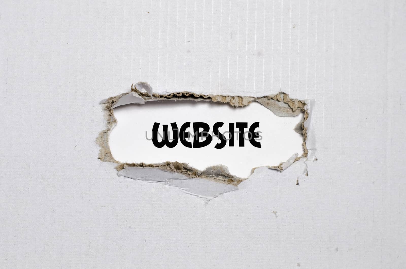 The word website appearing behind torn paper