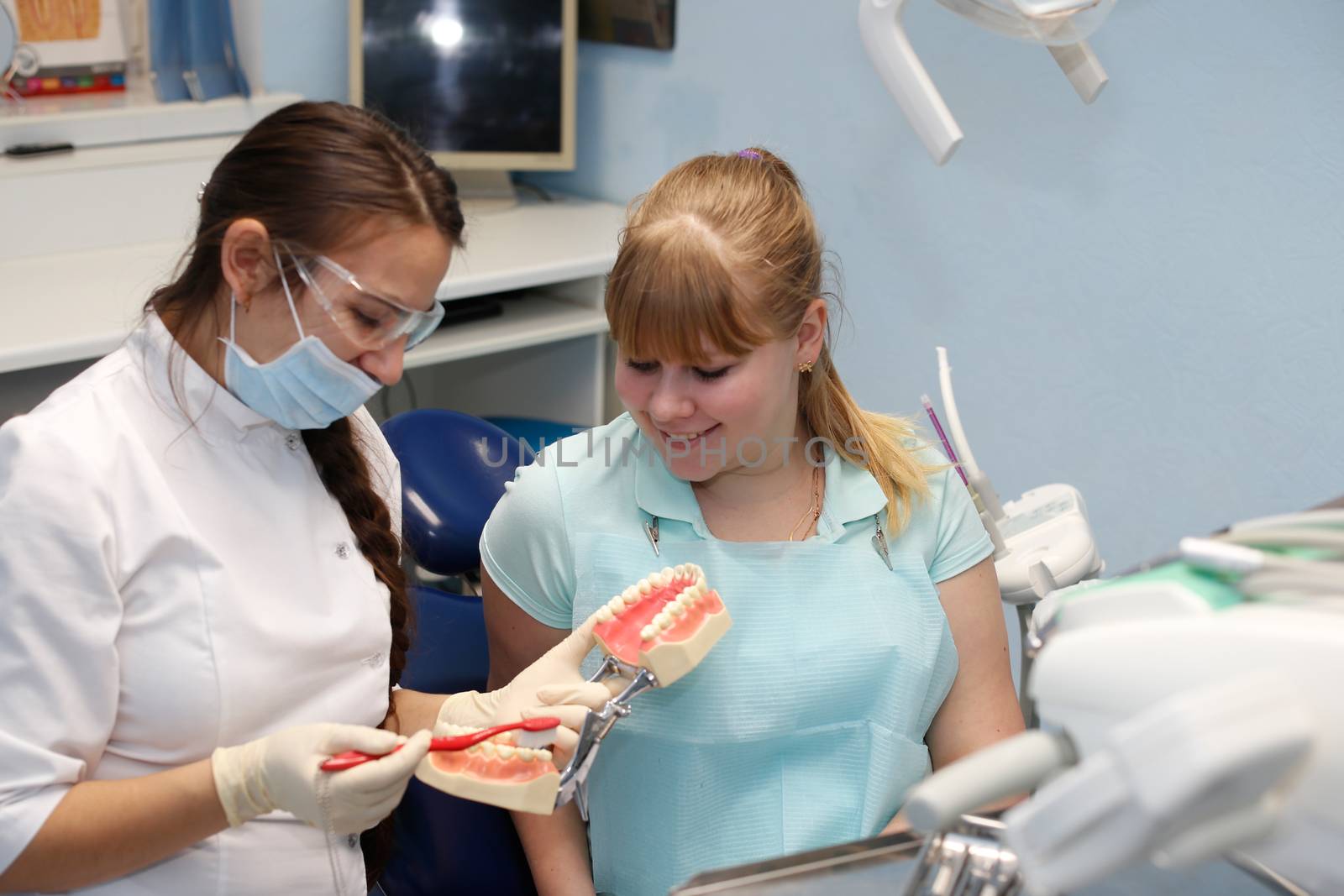 Dentist in a private office holds reception of the patient with pain. The Dentist Selects The Tool And Starts Examination Of The Teeth.