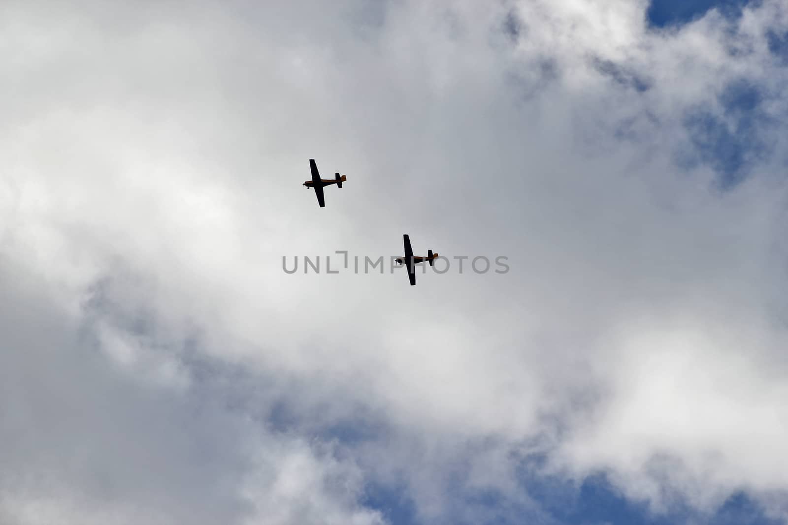 two airplans on the cloudy sky