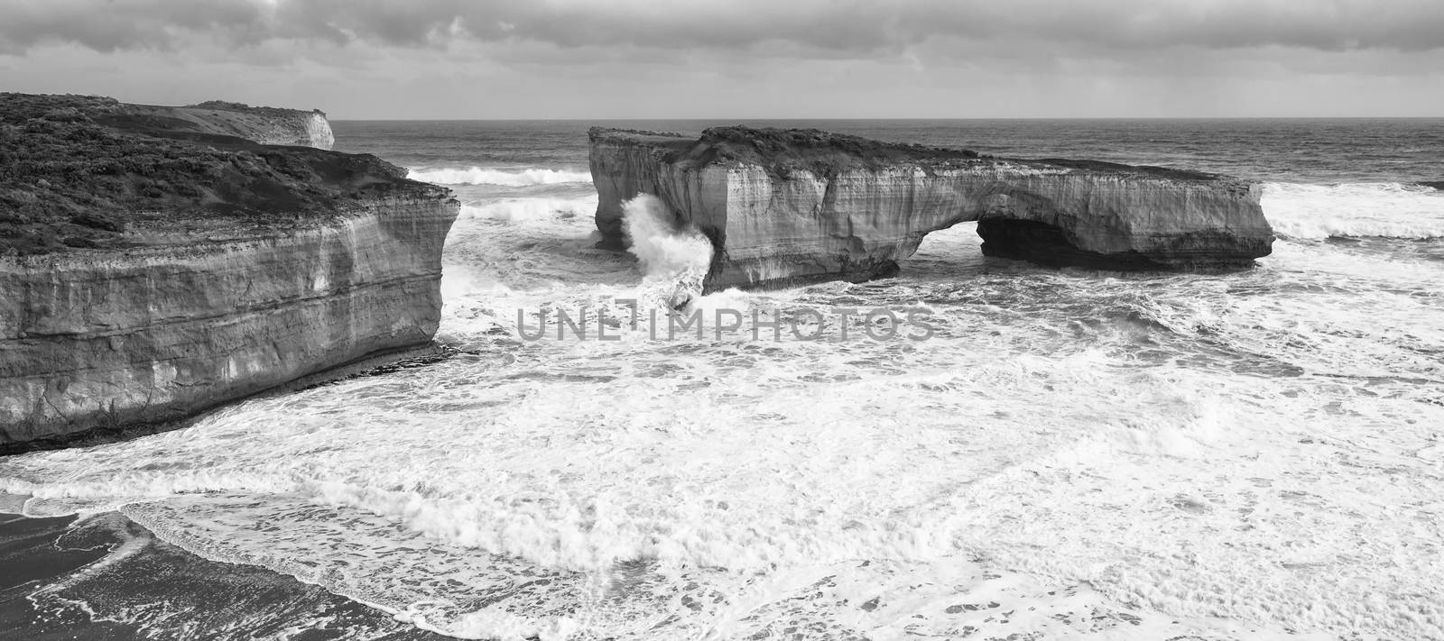 View of the London Bridge on Great Ocean Road during the day. Black and White.