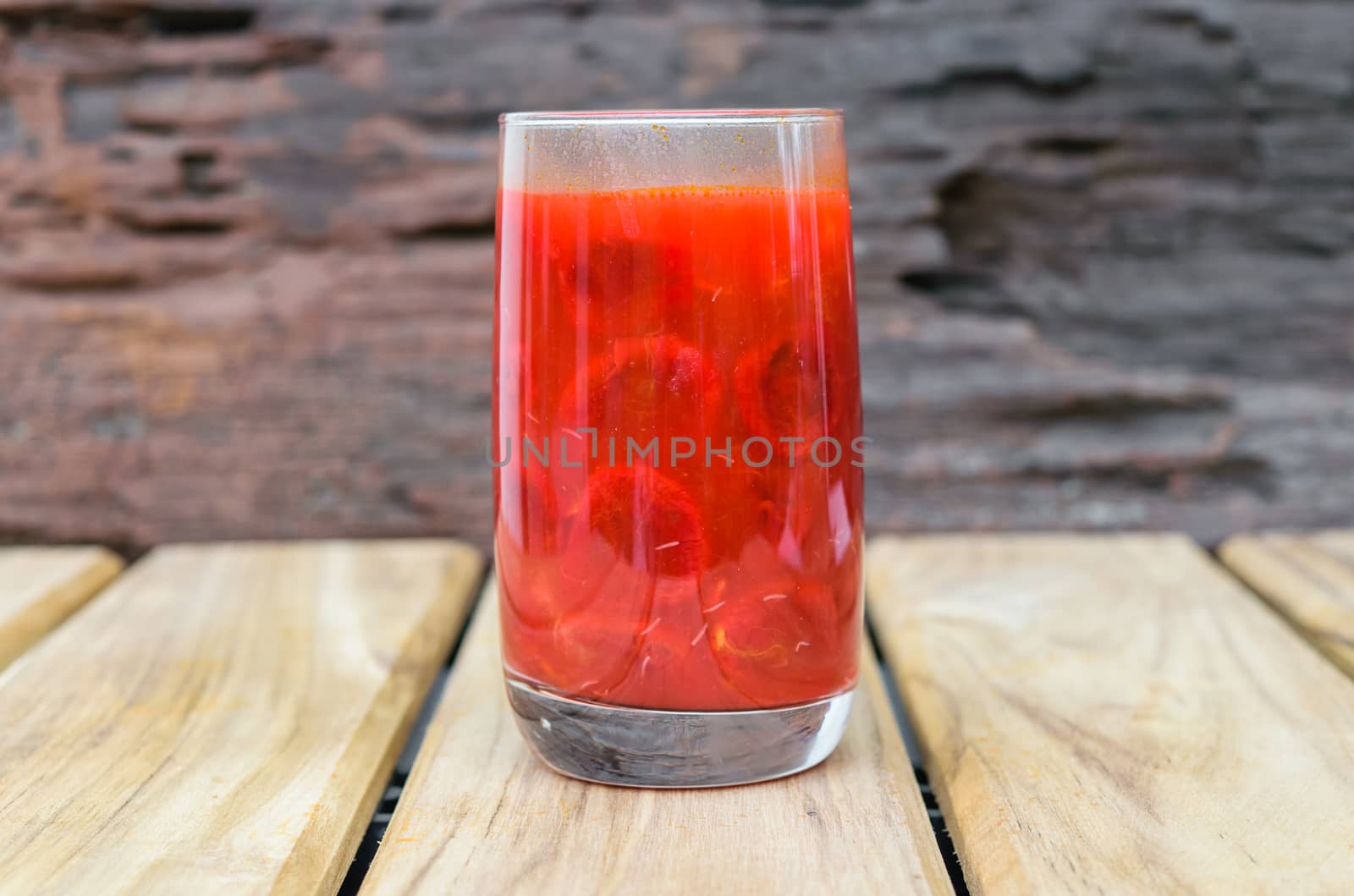 baby jackfruit spiny bitter gourd water in glass on wooden background