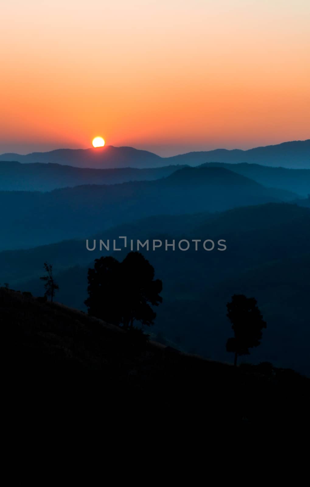 Sunrise on mountain by apichart