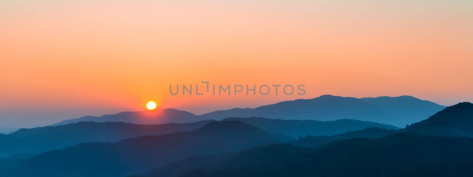 Sunrise on mountain by apichart