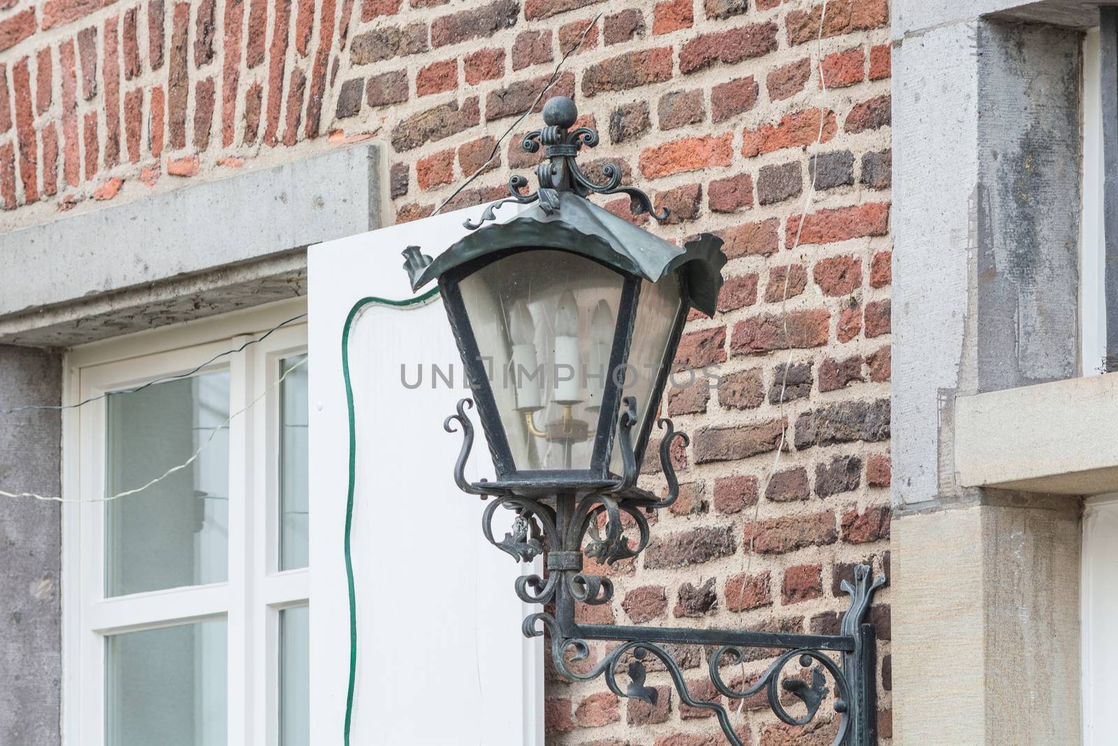Medieval illuminated street lantern made of wrought iron.