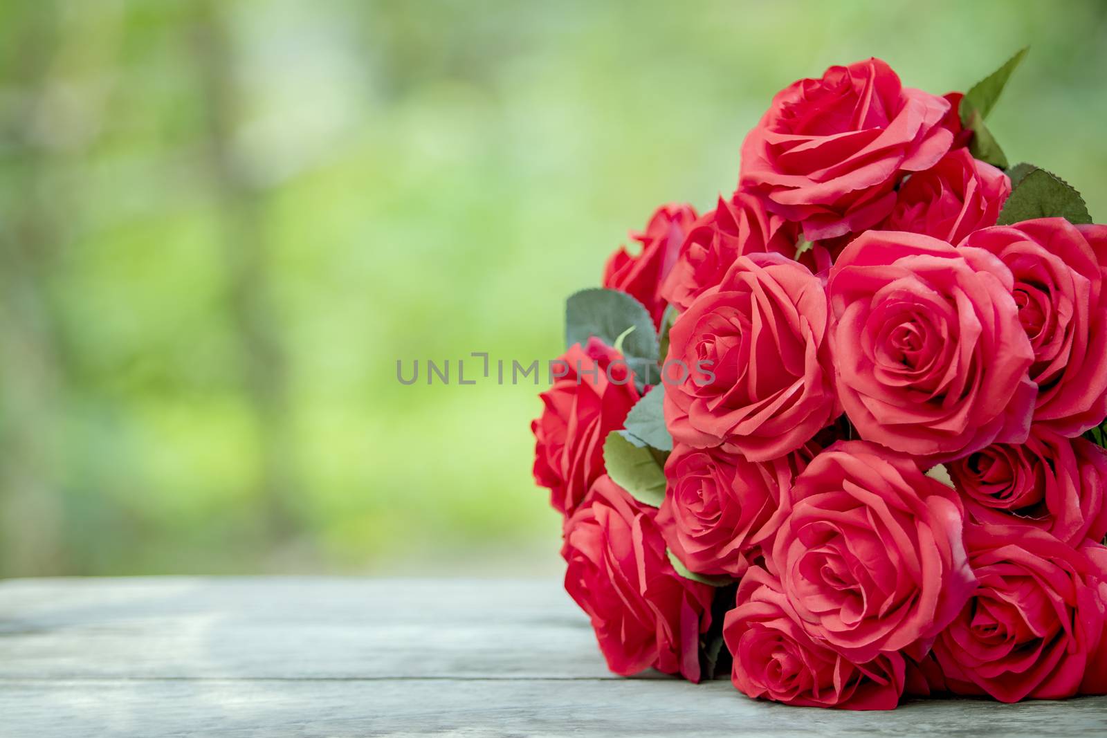 close up beautiful red roses bouquet with glowing light backgrou by khunaspix