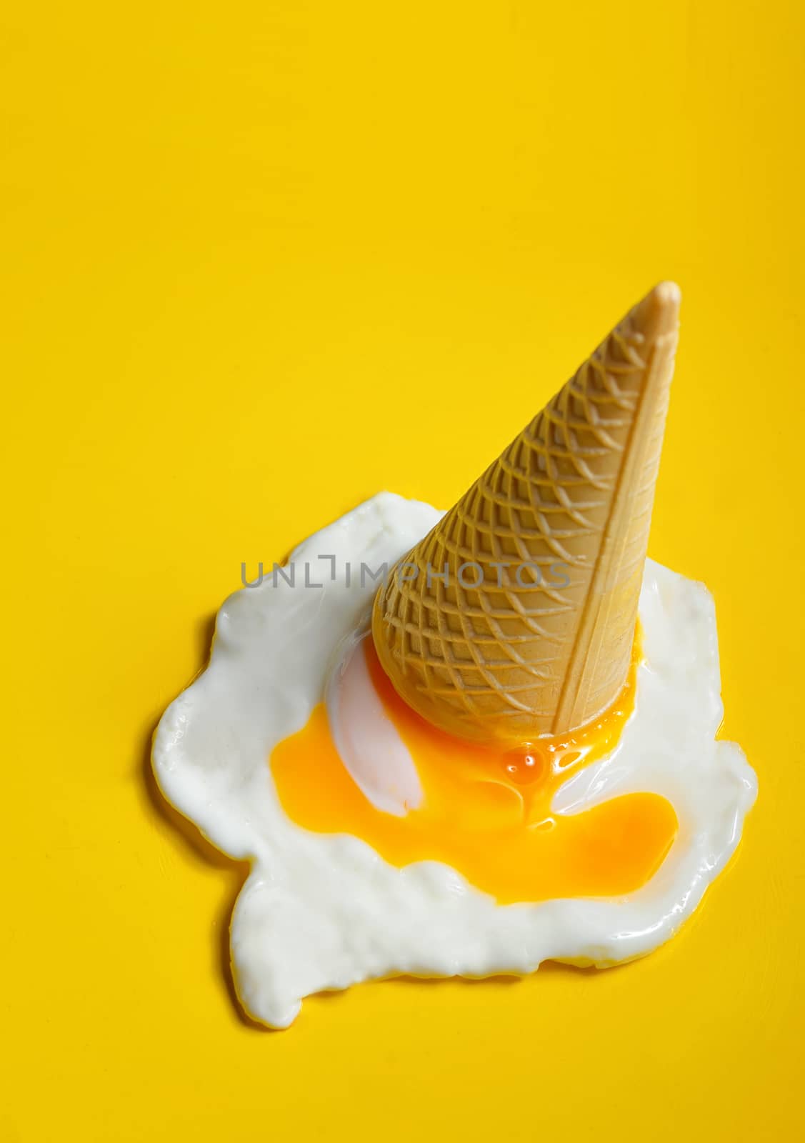 Ice cream cone dropped concept with fried egg