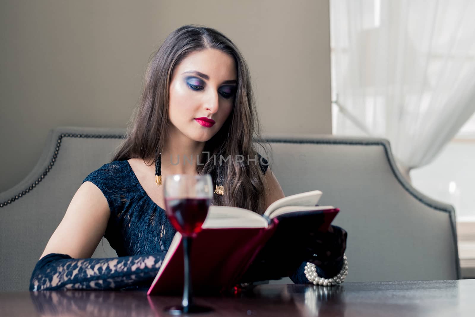 beautiful girl in a coffee shop reading a book