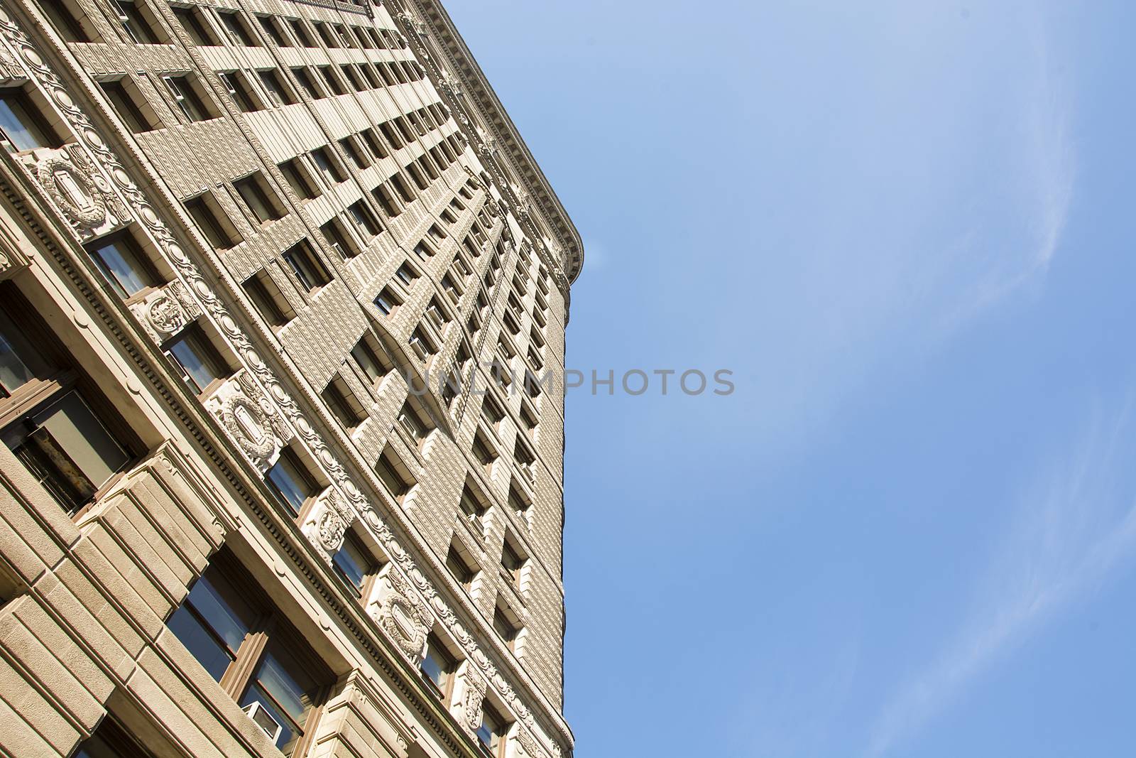 New York, USA, november 2016: Flat Iron building viewed from the bottom. Completed in 1902, it is considered to be one of the first skyscrapers ever built.