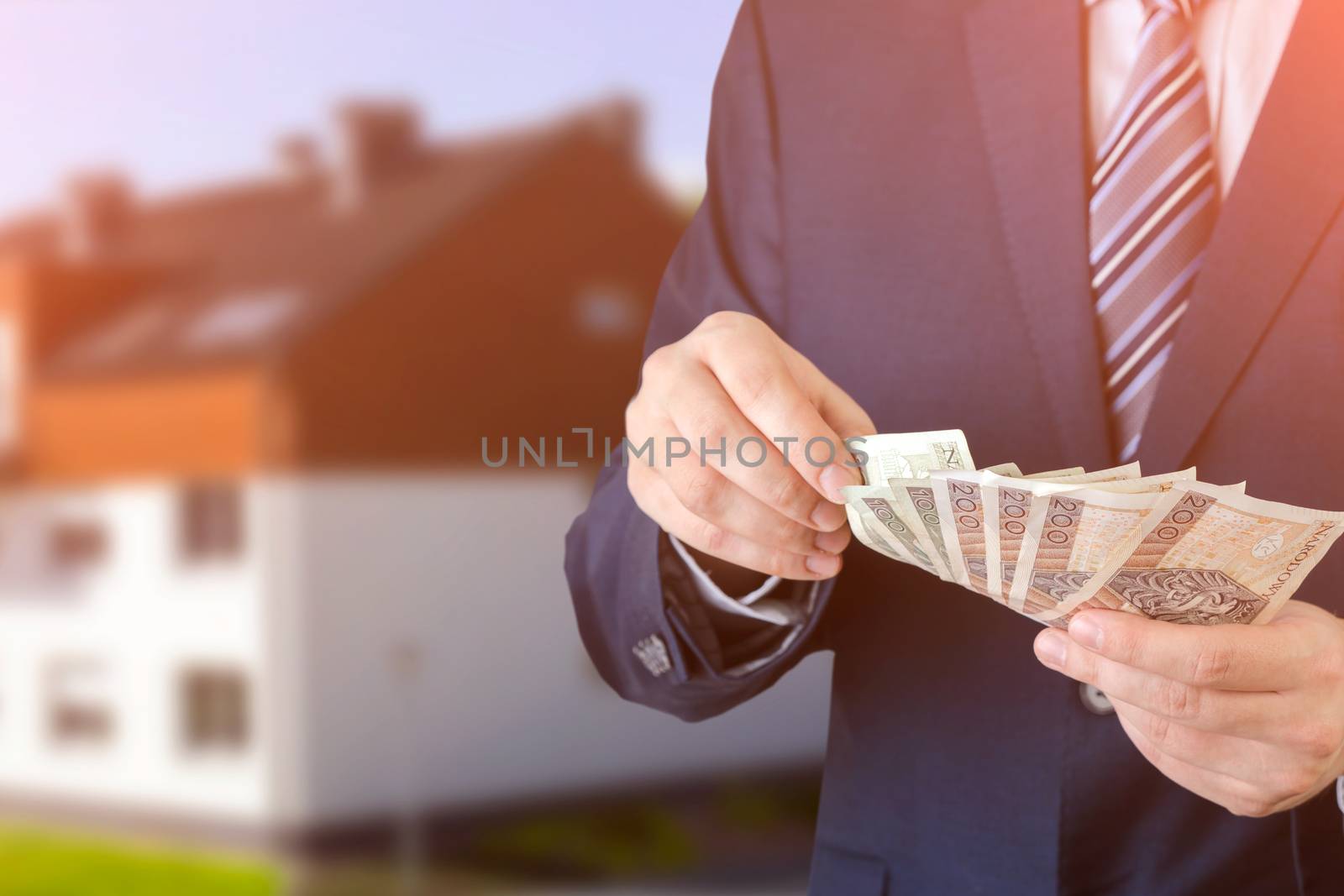 Polish businessman holds money. The loan on the house. Money loan polish pln cash banknote apartment flat concept