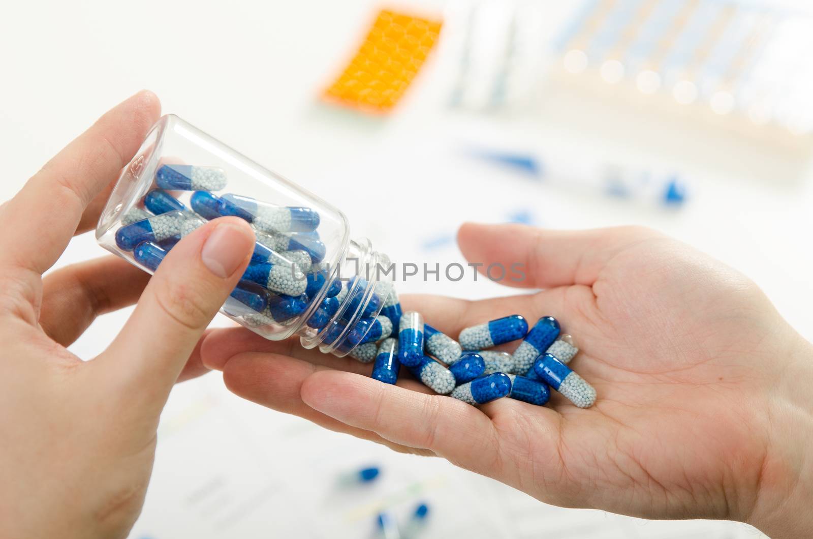 Person pouring out pills on hand. pill doctor hand pour capsule bottle closeup pills concept