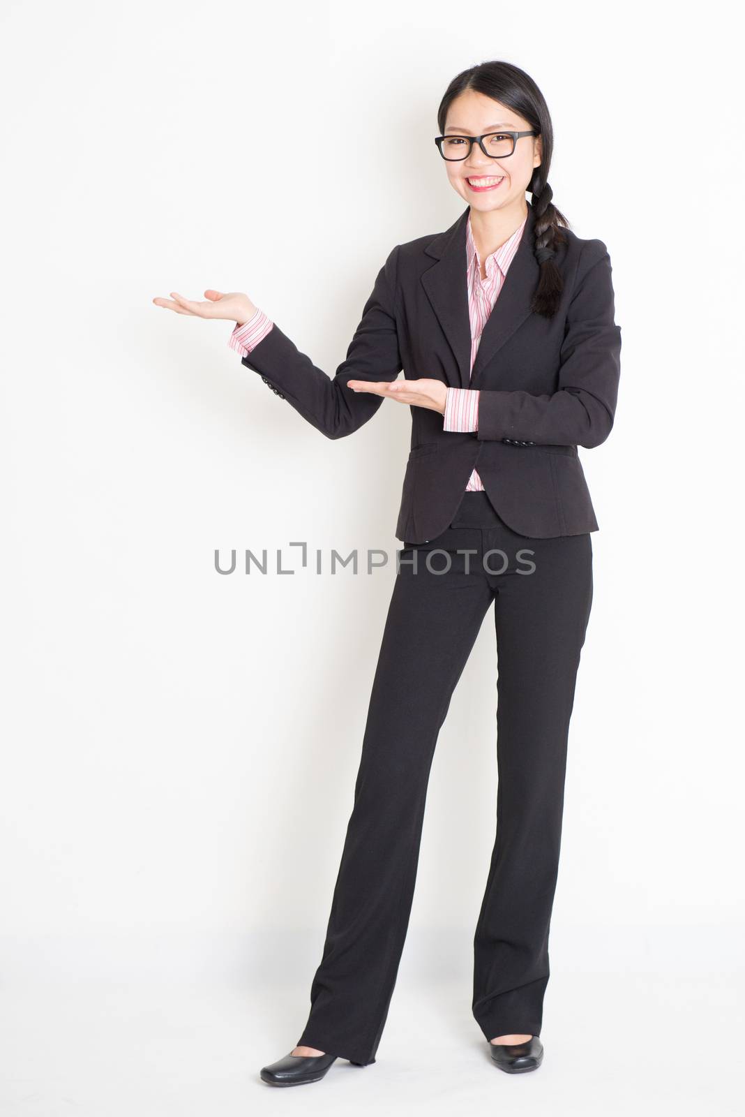 Asian businesswoman showing something by szefei