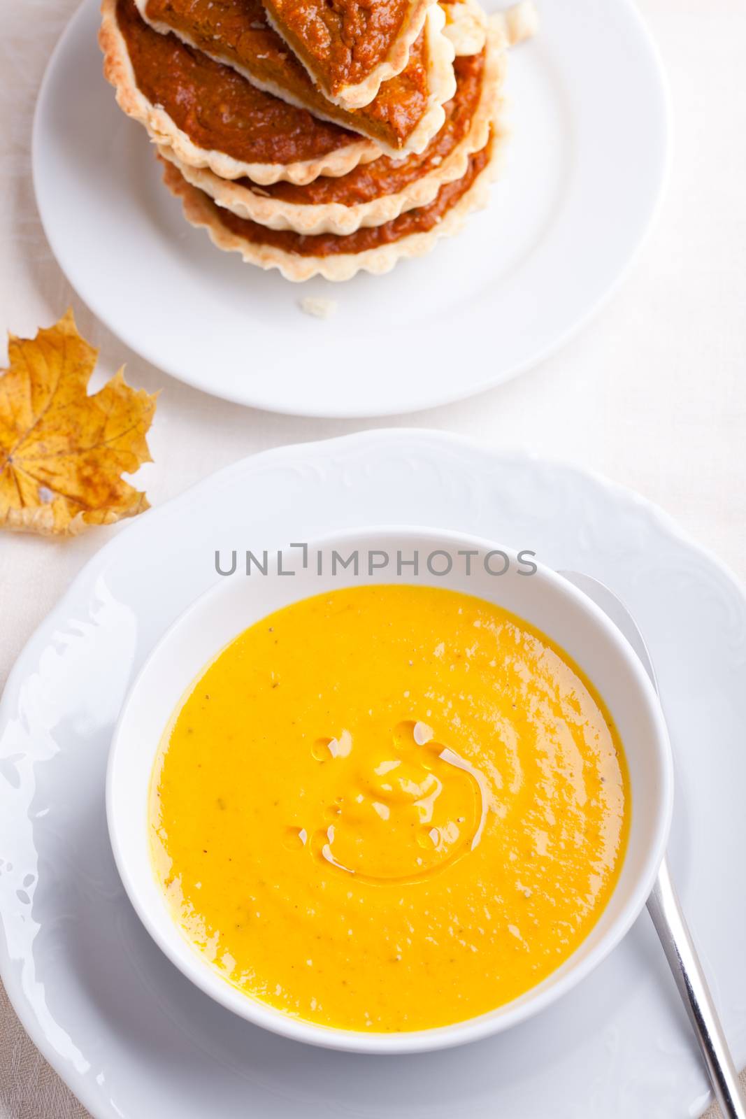 Pumpkin creme soup and pumpkin pie on a table