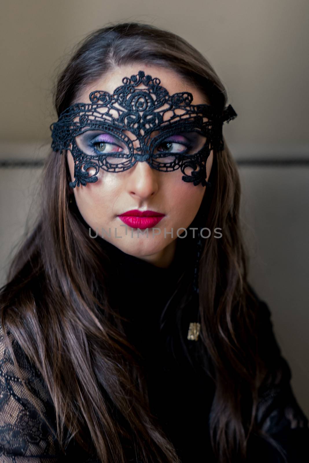 Portrait of a beautiful girl with black mask