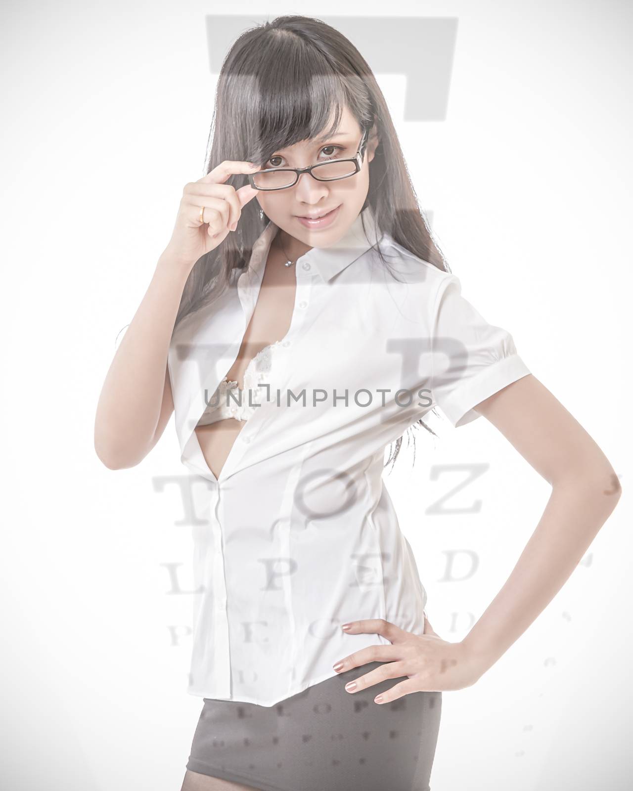 Beautiful Asian woman wearing glasses with eyesight test chart overlay
