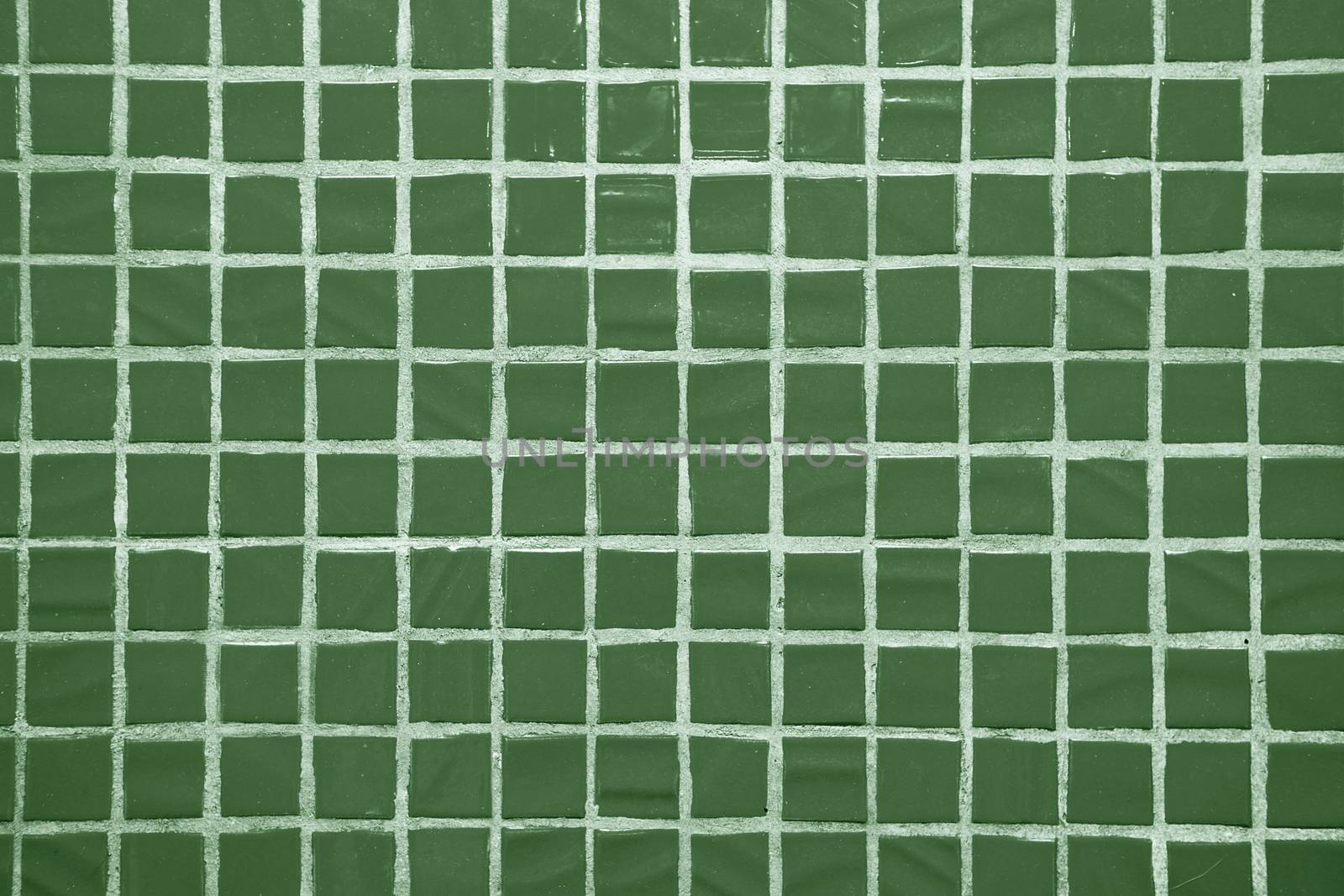 Texture of fine little ceramic tiles background. Green floor tiles
