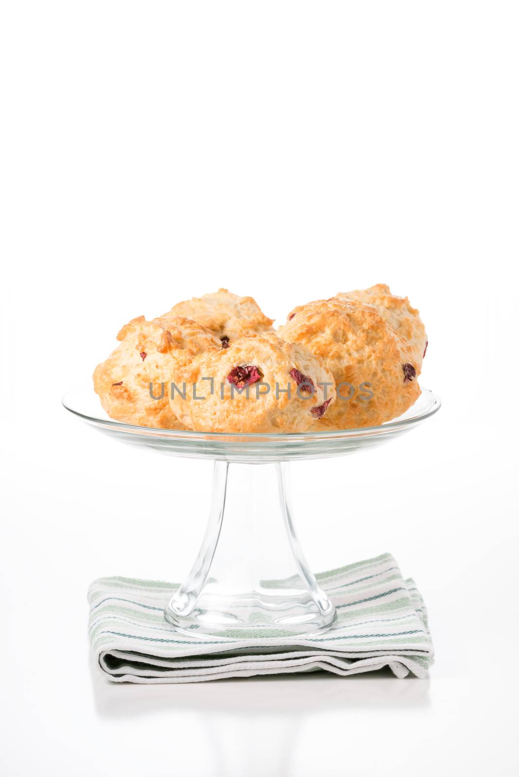 Fresh lemon cranberry scones on a glass presentation platter.