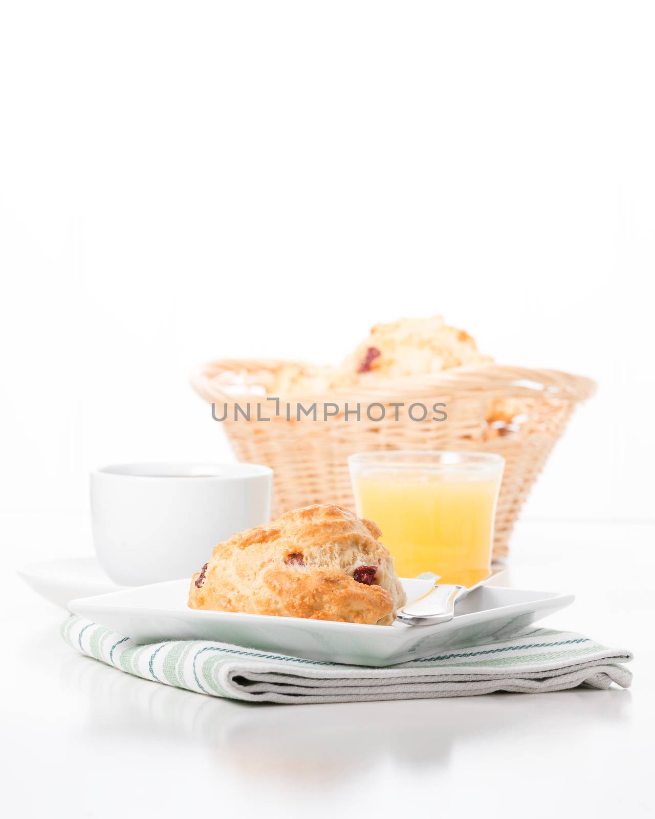 Fresh cranberry lemon scones served with coffee and juice.