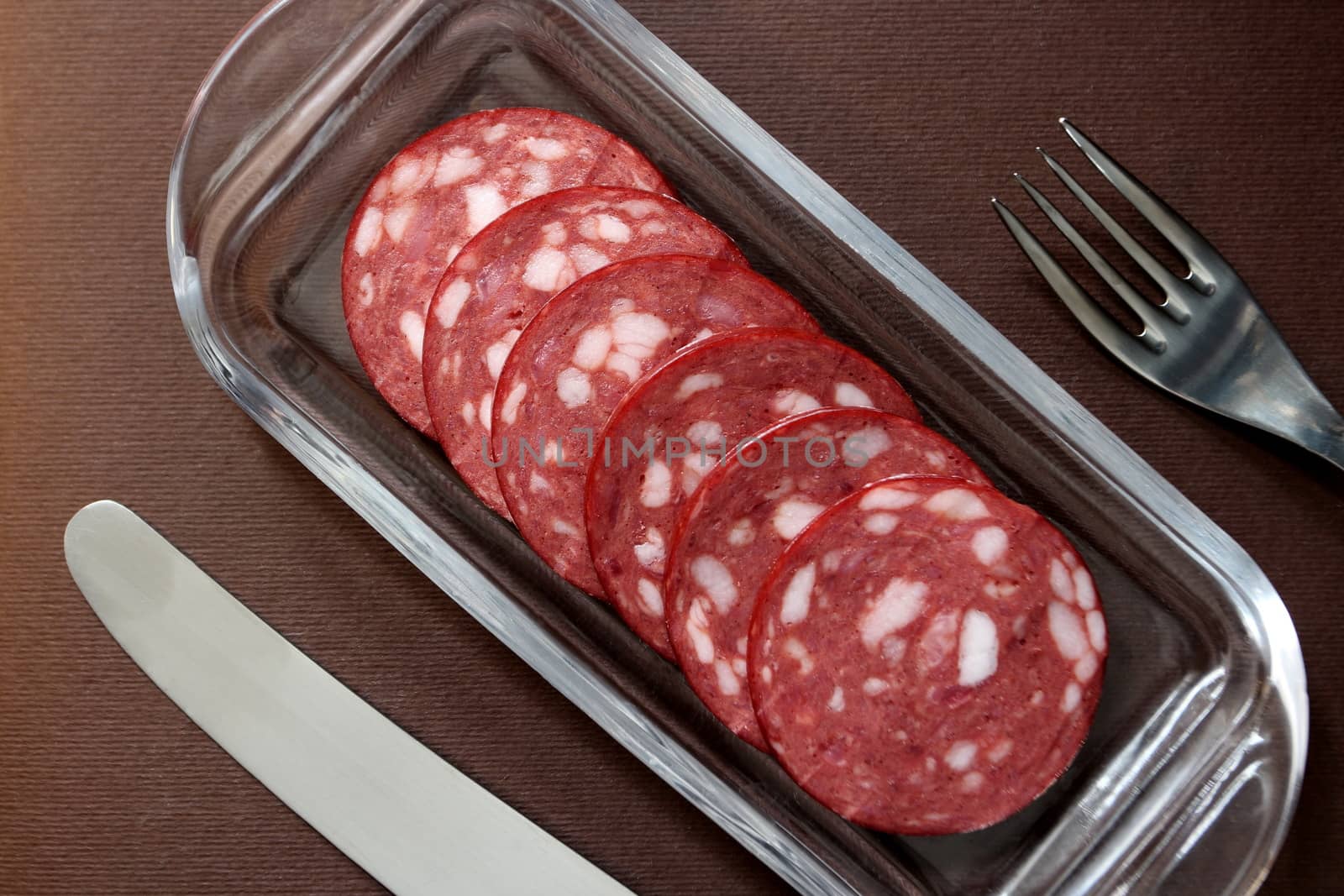 slices salami on a plate by mrivserg