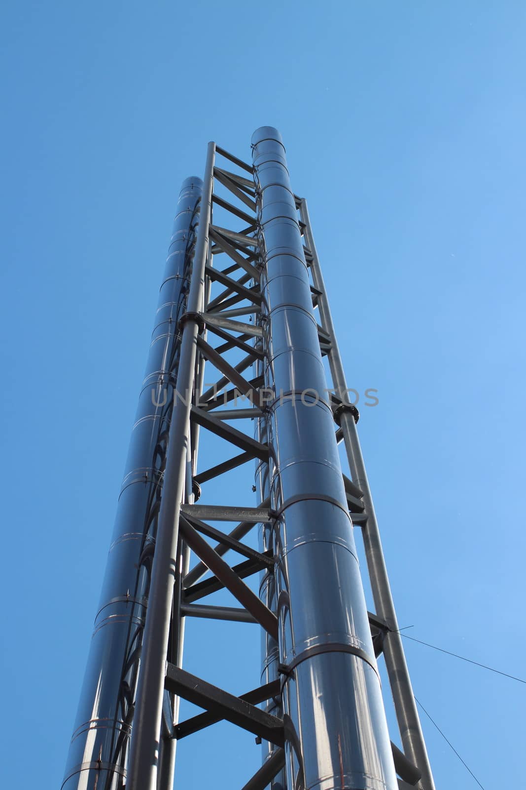 smokestack with stainless steel against a background of blue sky