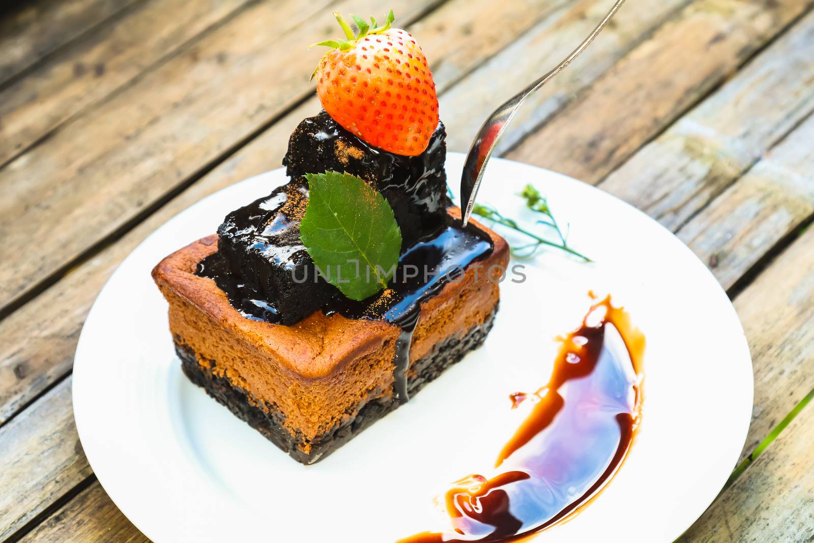 chocolate cake on white dish with strawberry by luckyfim