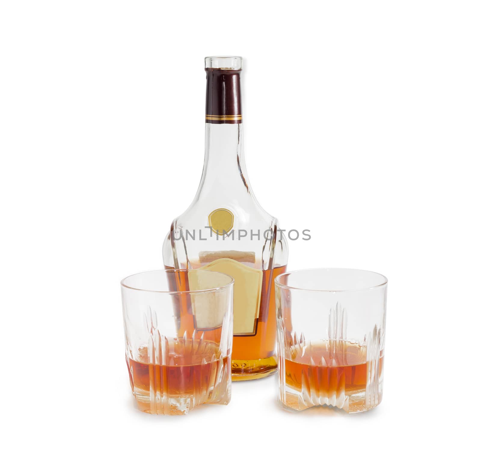Opened bottle of whiskey and two glasses with whiskey on a light background
