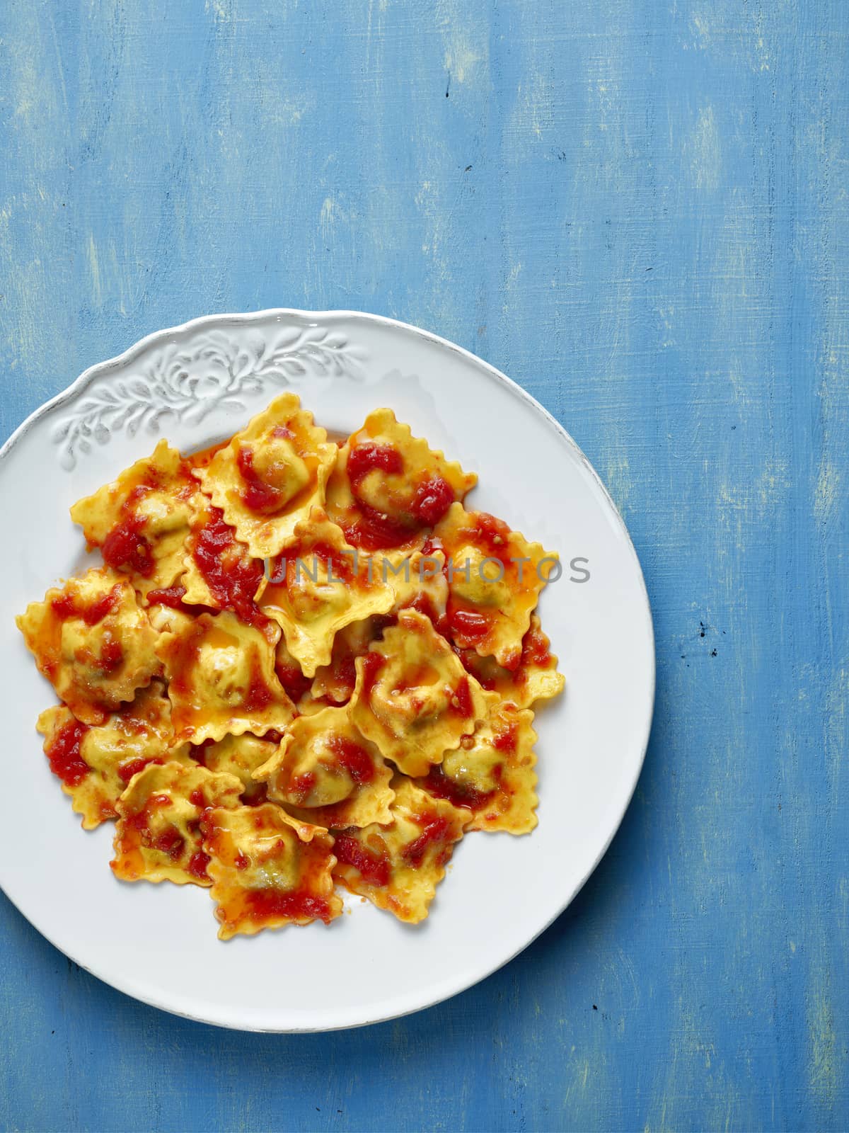 close up of a plate of italian ravioli pasta in tomato sauce