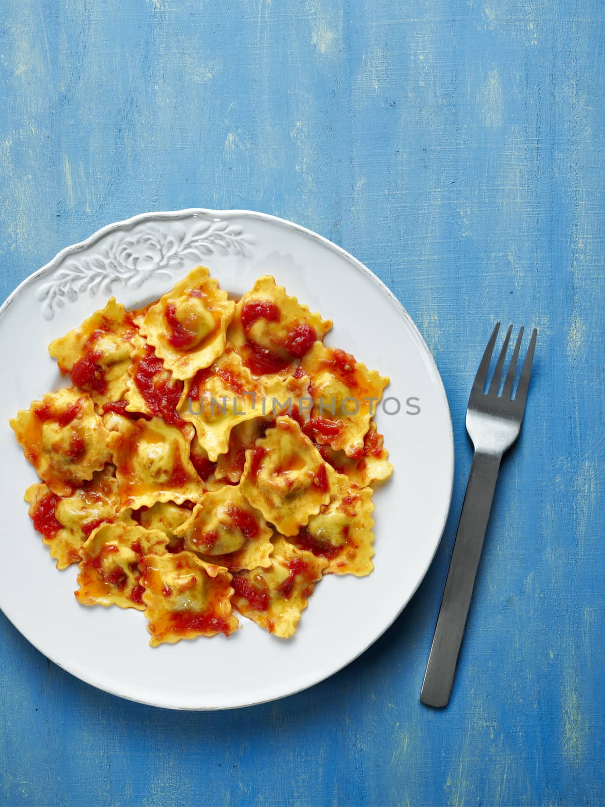close up of a plate of italian ravioli pasta in tomato sauce