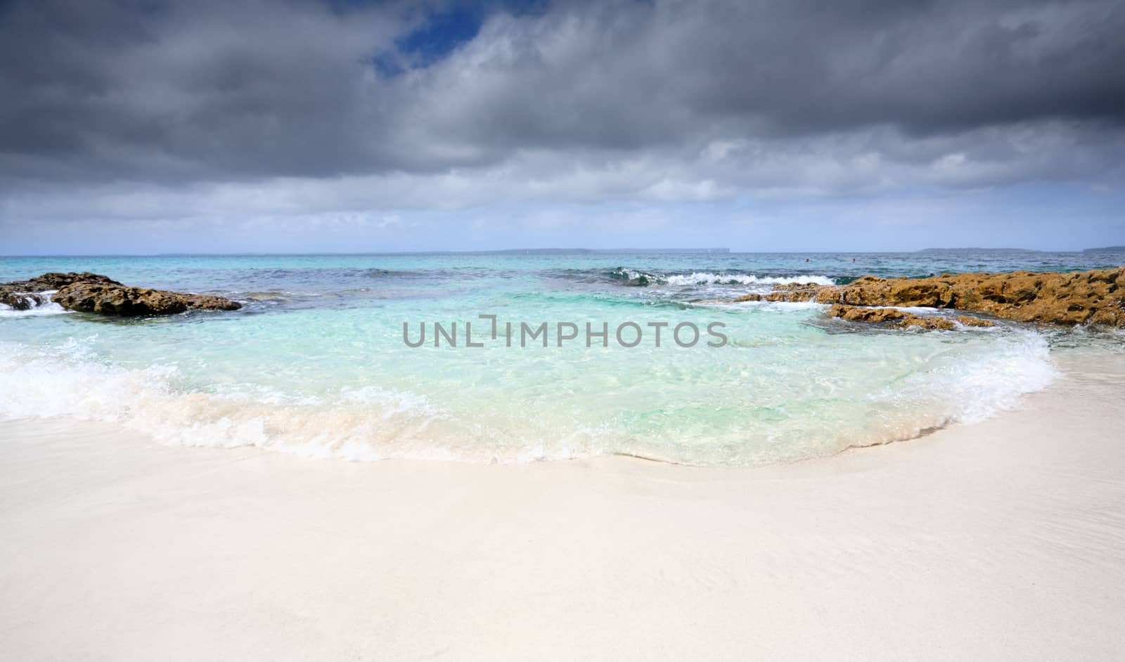Water flowing in onto the pristine sands of an idyllic beach