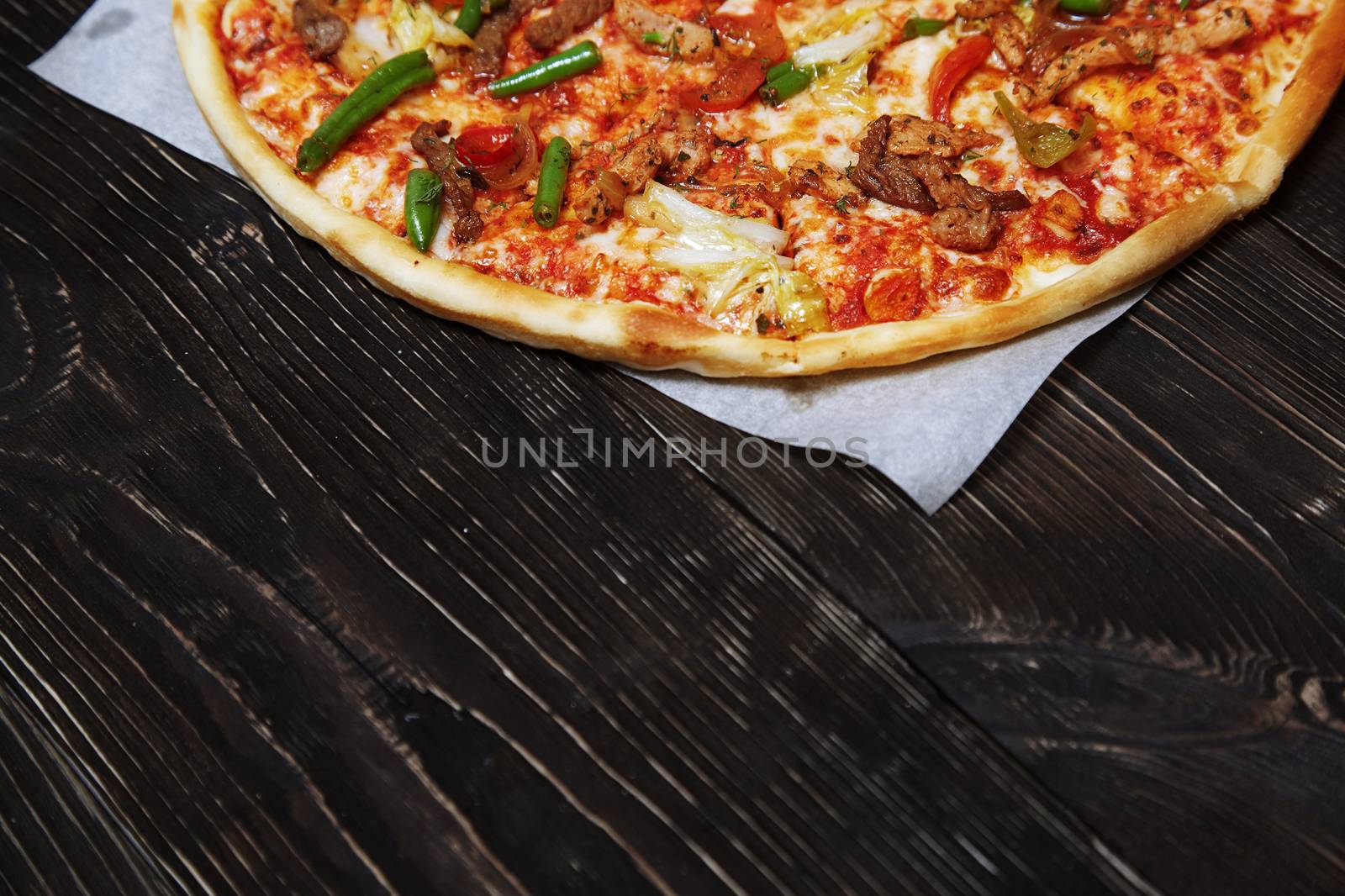 Homemade pizza on a wooden table by Novic