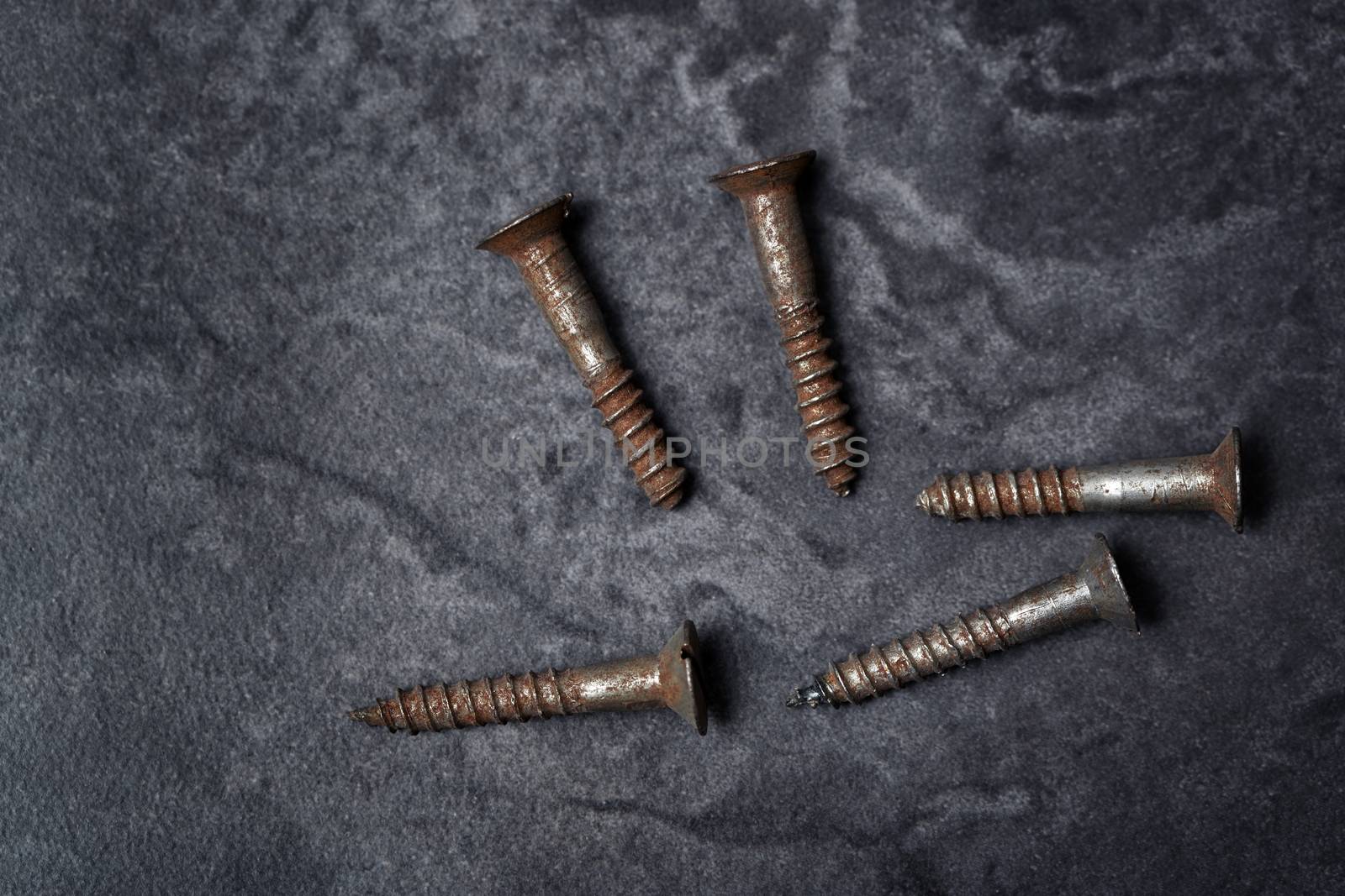 Group of rusty screws. Close-up vertical photo