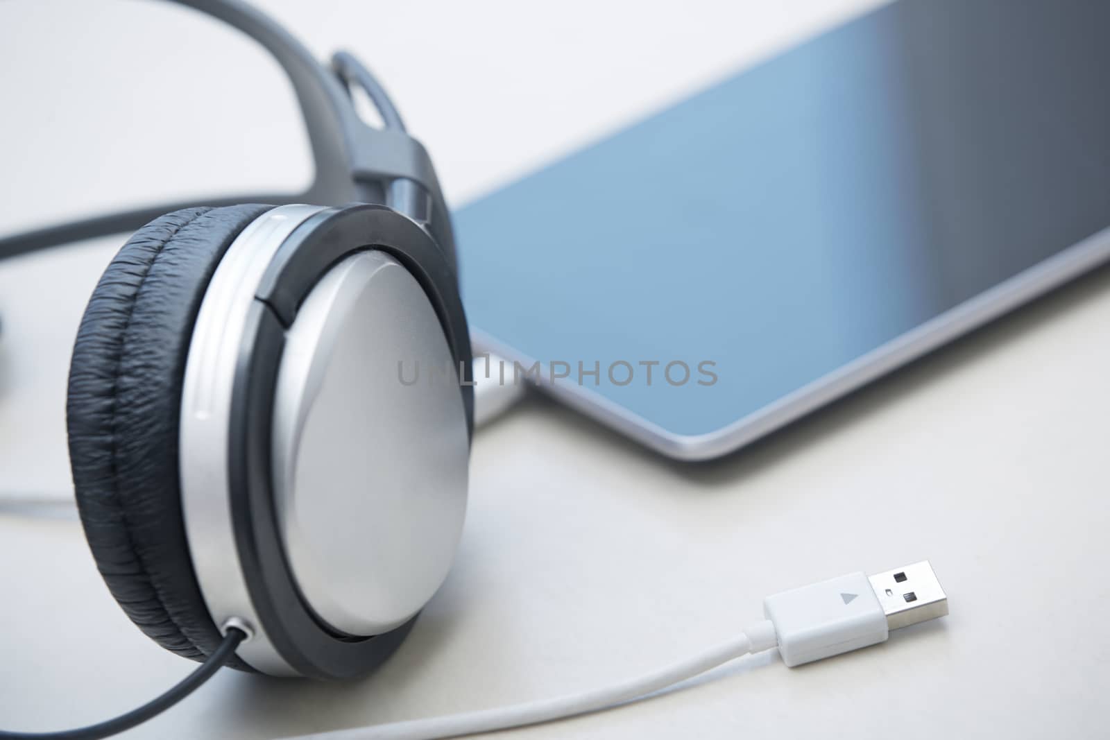 Headphones and digital tablet on a table