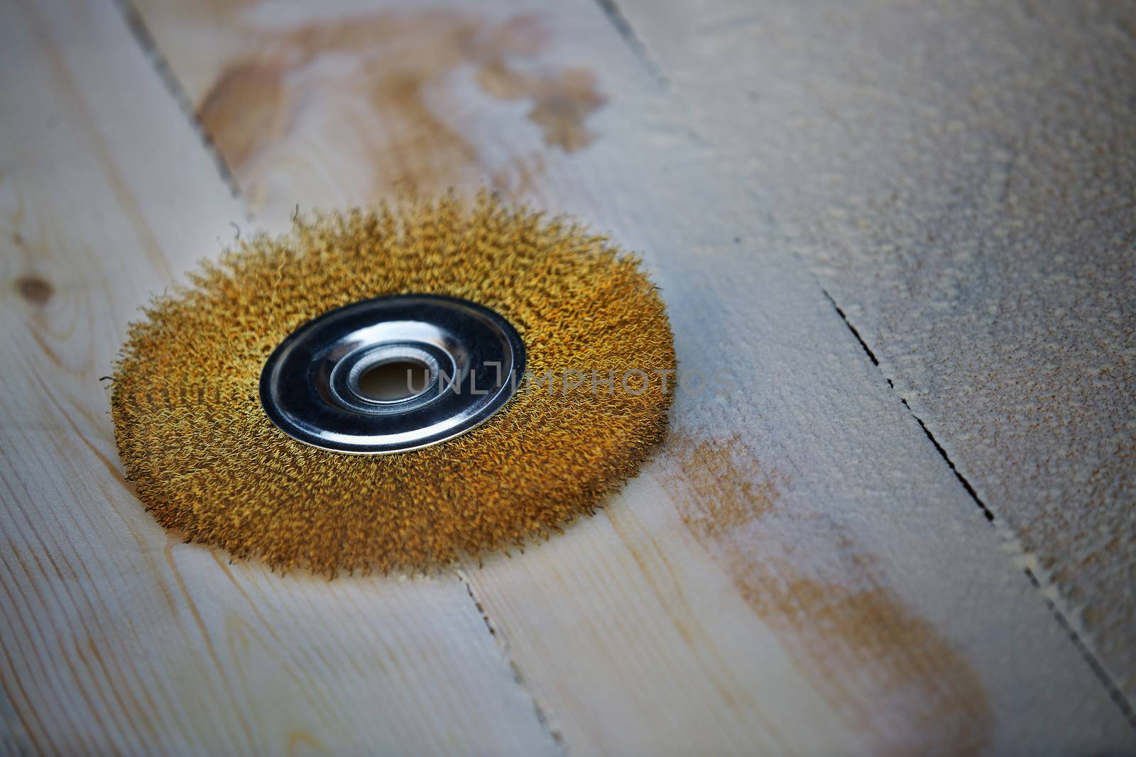 Grinding disk on a wooden planks in carpentry workshop