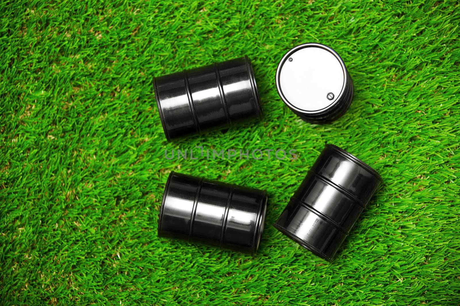 High angle view on four oil barrels on a grass by Novic
