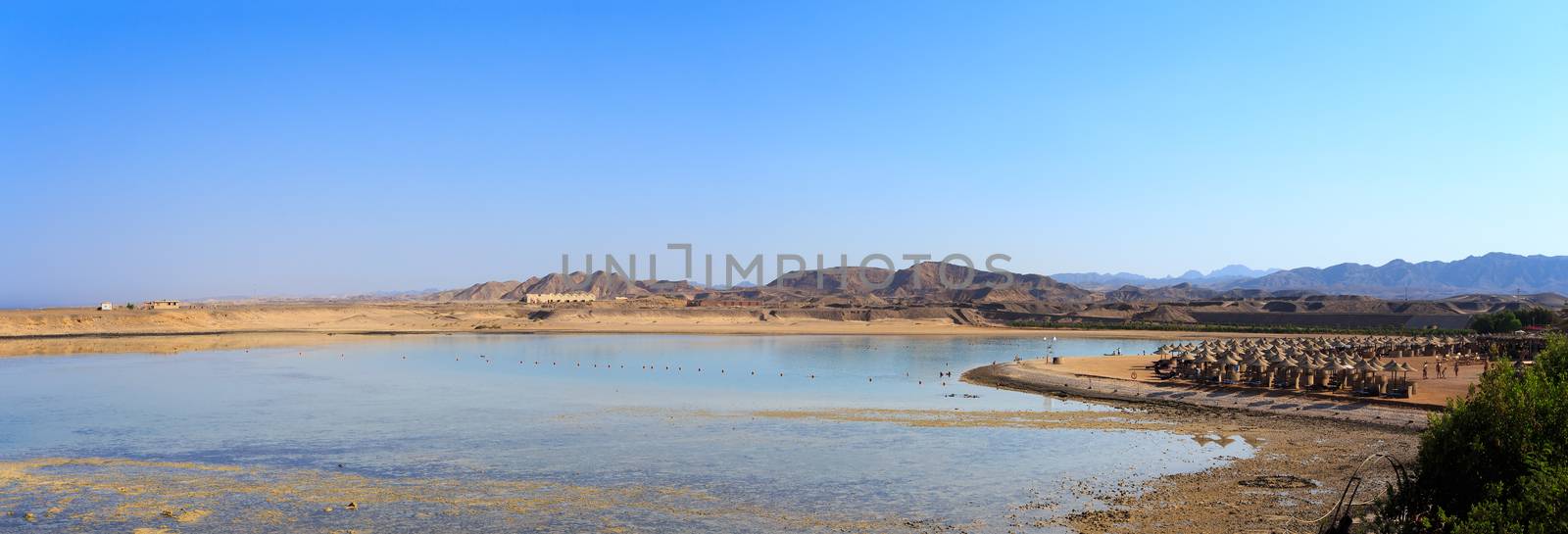 panorama of egypt paradise beach with sun parasol and blue sky . holiday summer vacation concept