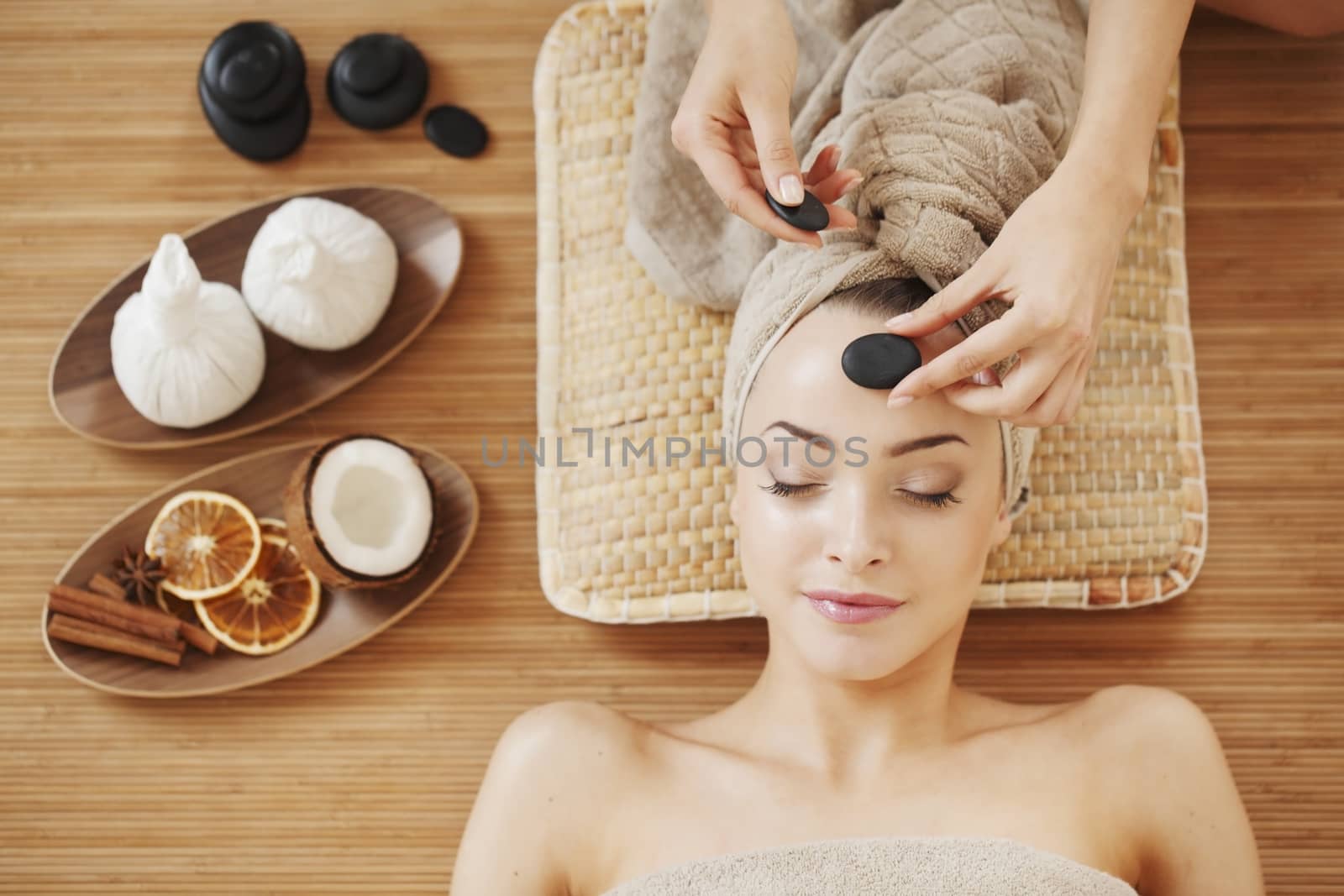 Beautiful young woman relaxing in spa salon