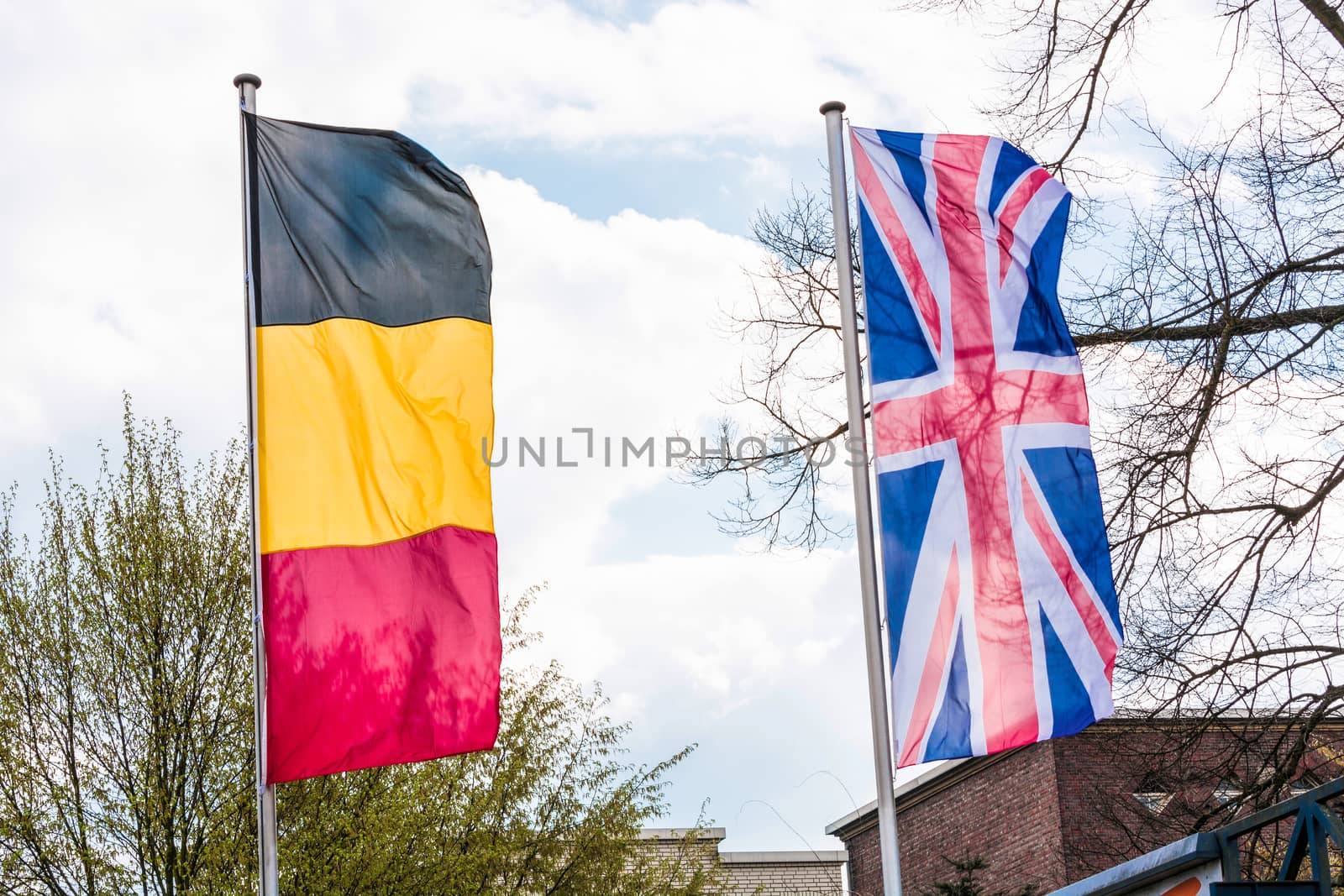 Several Europe countries flags arranged in front of a blue sky.