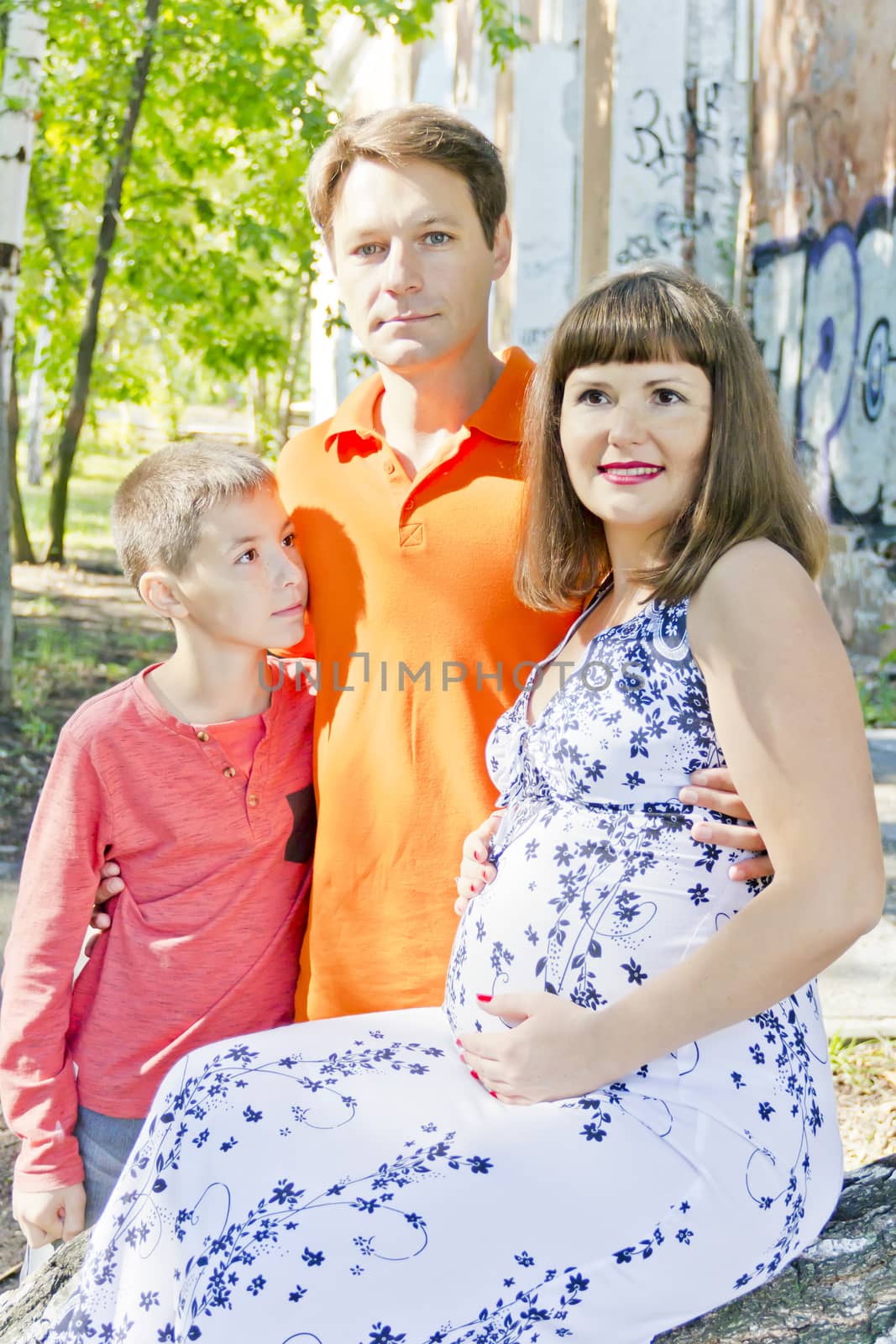 Family is pregnant mother father and son by Julialine