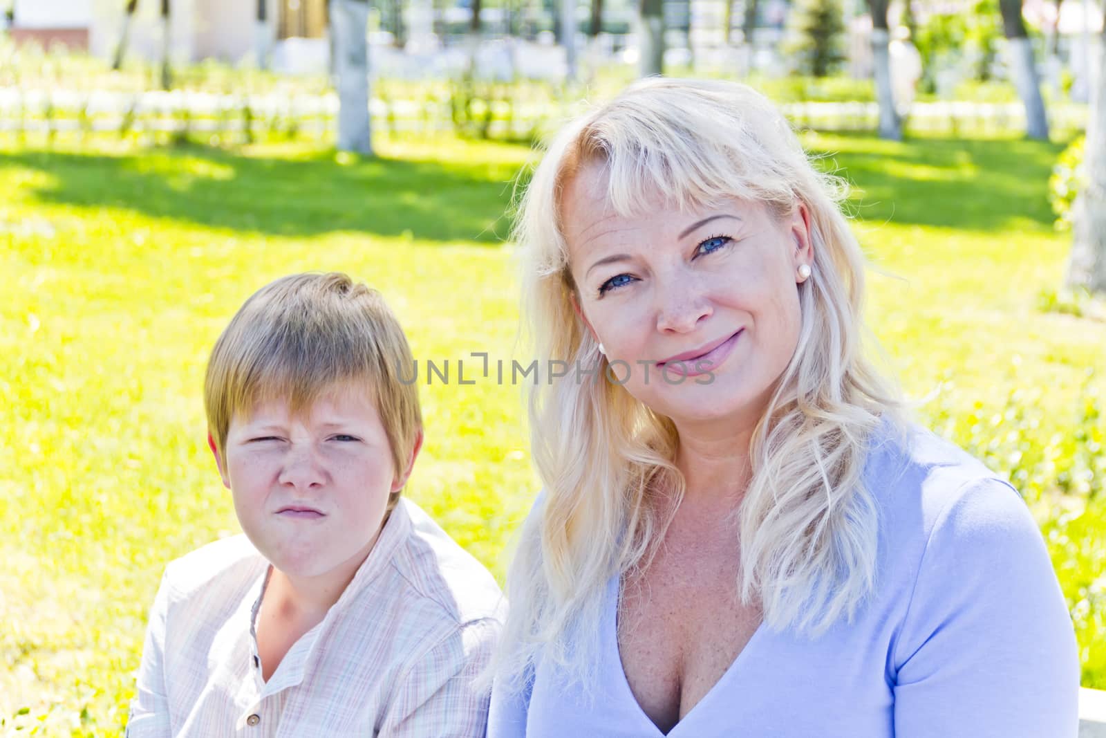 Portrait of European beautiful woman with pose face son in park
