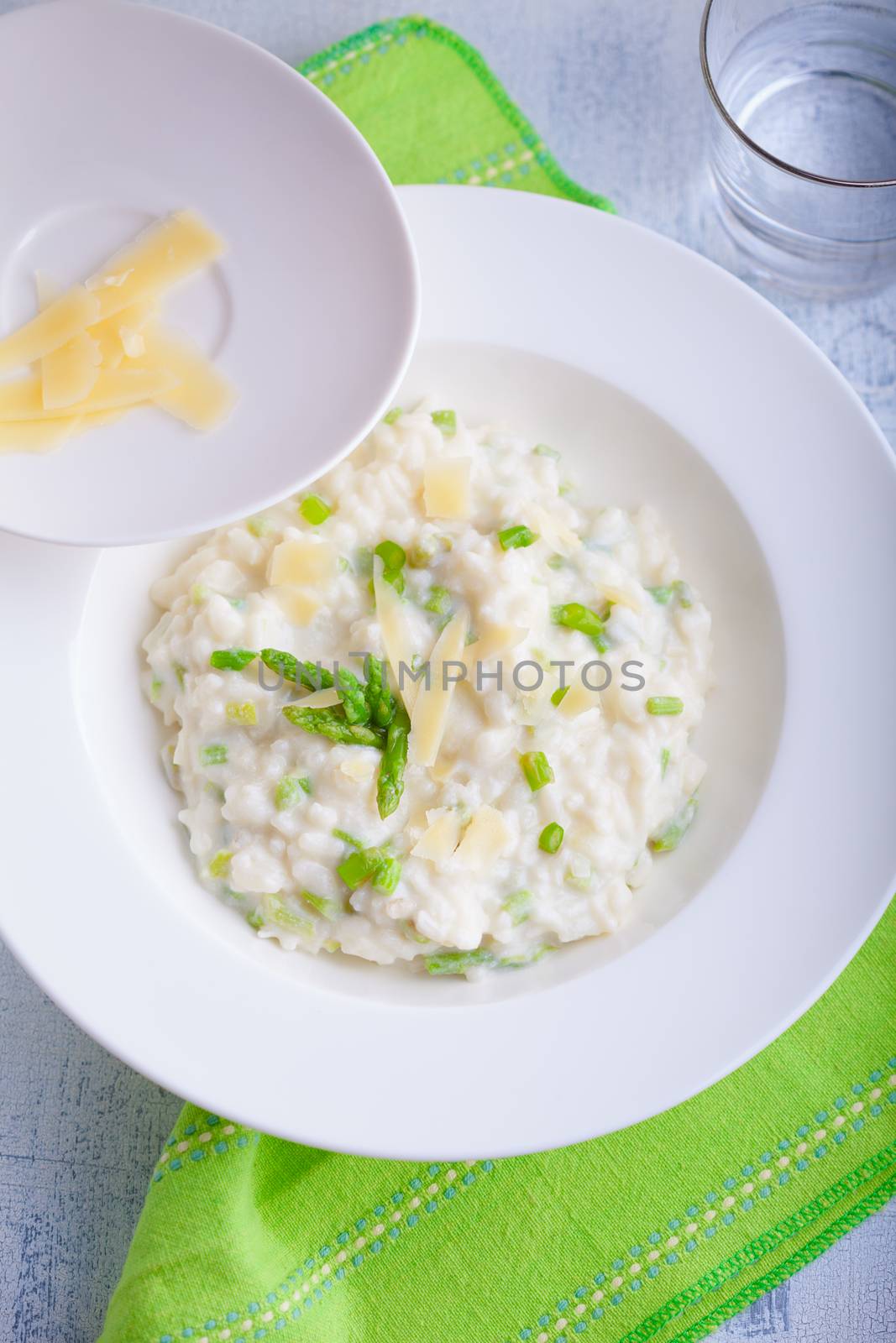 Risotto with Asparagus and cheese served on a table. by supercat67