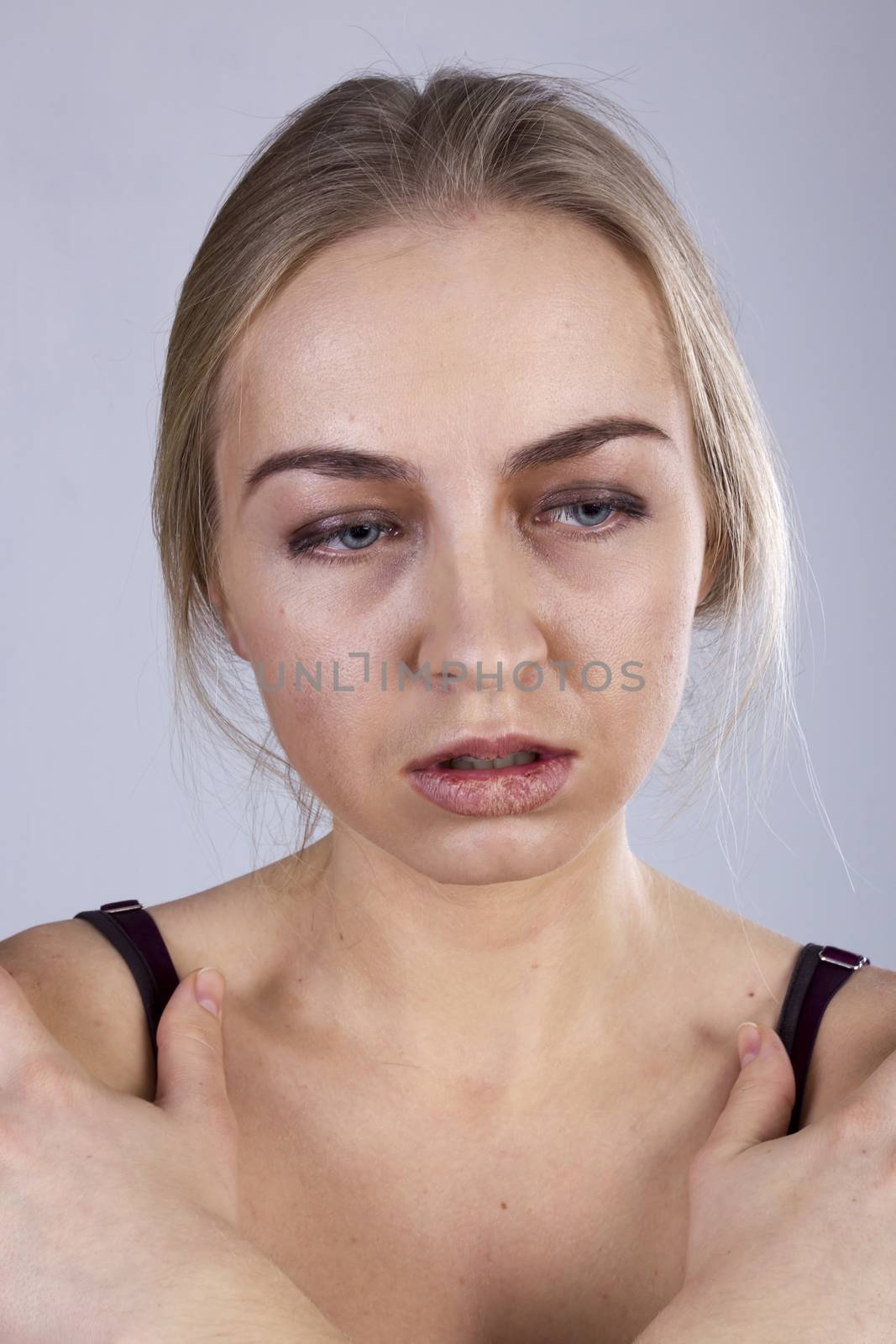 Portrait of a young woman in a gloom on the gray background. Seven Deadly Sins