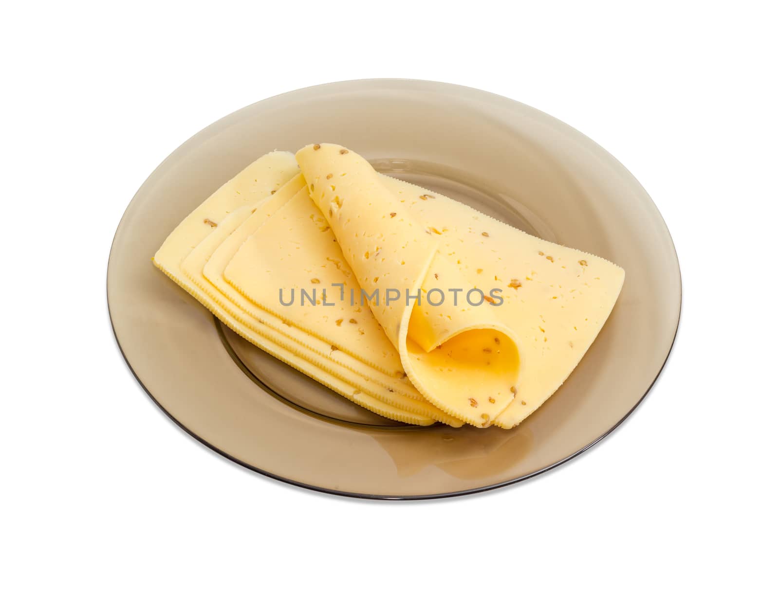 Several slices of a semi-hard cheese made with pounded walnuts on a glass dish on a light background
