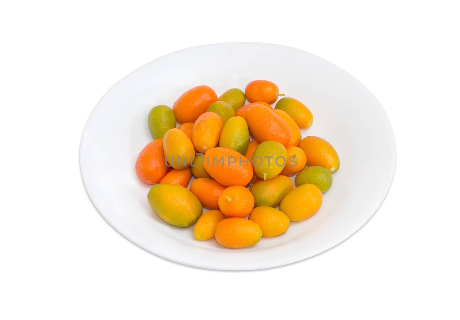 Fresh kumquats on a white dish on a light background
